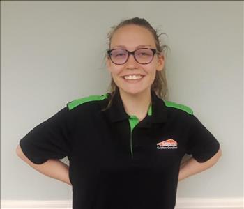 Young lady wearing a SERVPRO polo and glasses